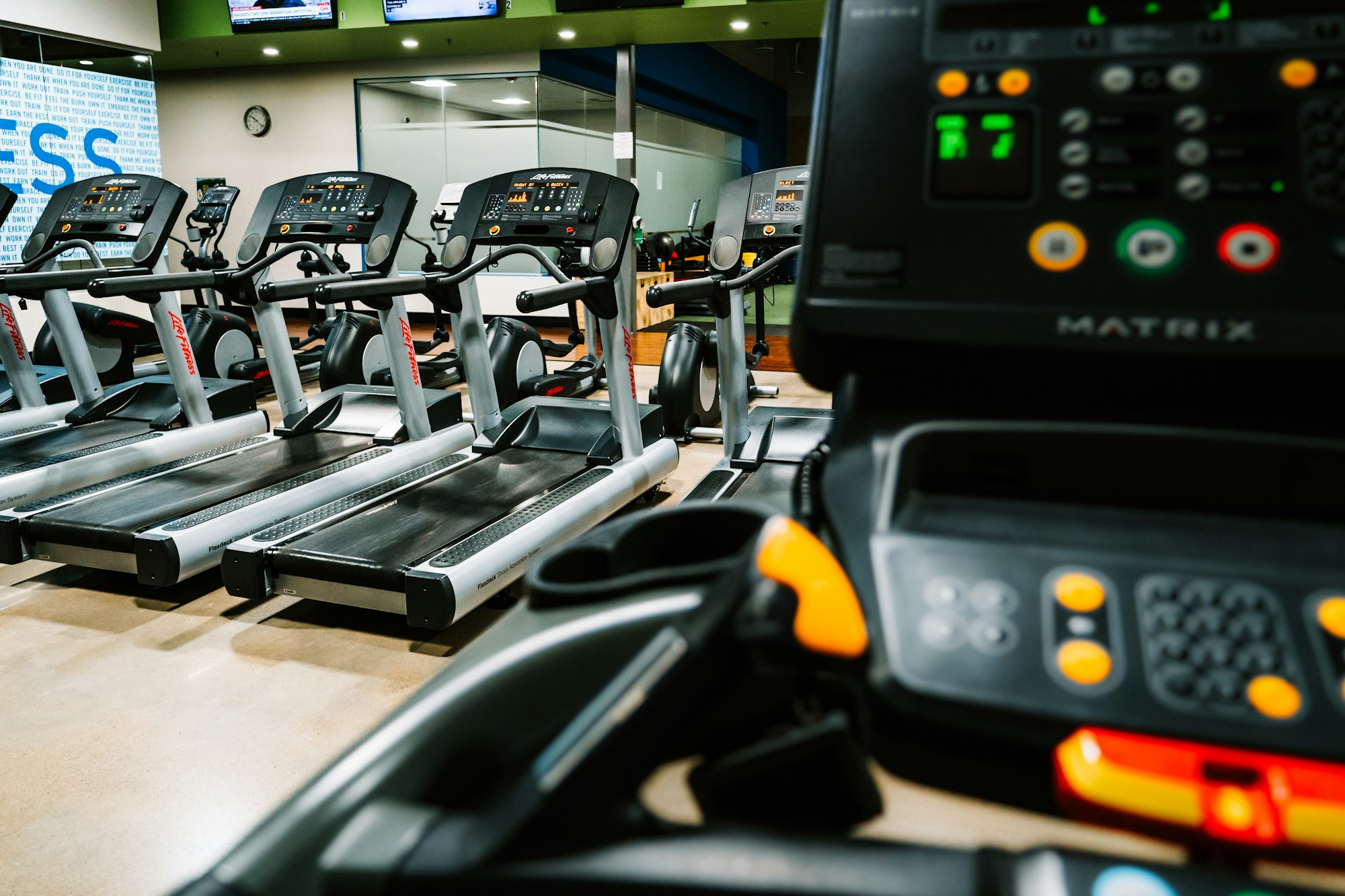 A runner on a treadmill in an empty gym — running fast and going absolutely nowhere, the perfect visual metaphor for the AI coding productivity paradox