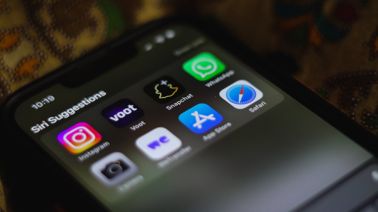 iPhone home screen showing Siri Suggestions with app icons — representing how AI-powered discovery is becoming the primary way users find and launch apps