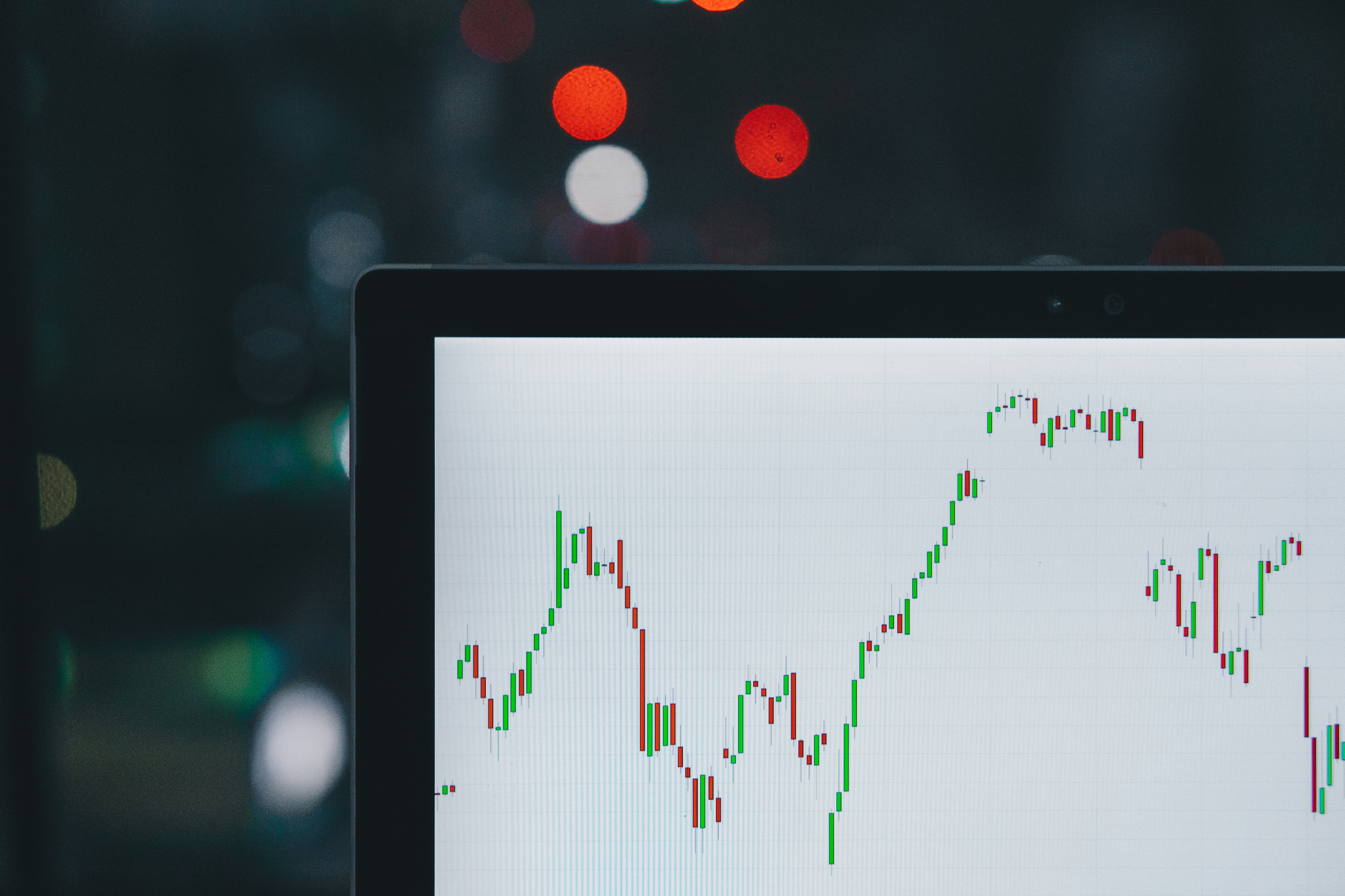 A financial growth chart on a monitor with bokeh lights in the background — representing the explosive App Store growth in 2026