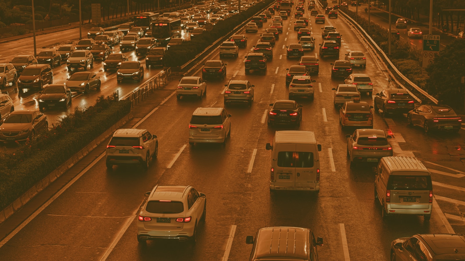 Heavy traffic congestion on a multi-lane highway at dusk — representing the App Store review queue gridlock caused by vibe coding's 84 percent submission surge in 2026