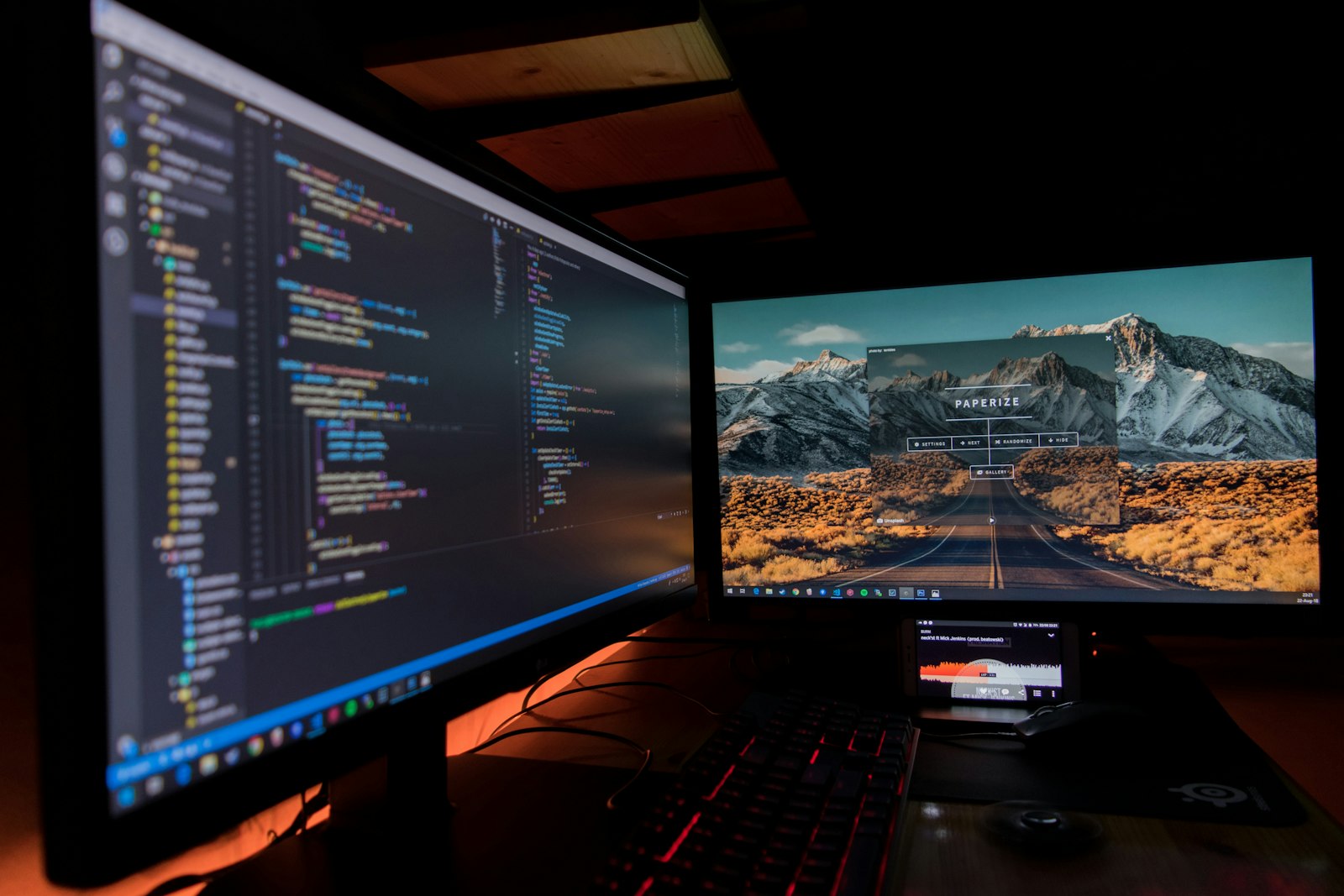 Two monitors displaying code side by side — representing the Claude Code vs Cursor developer tool comparison