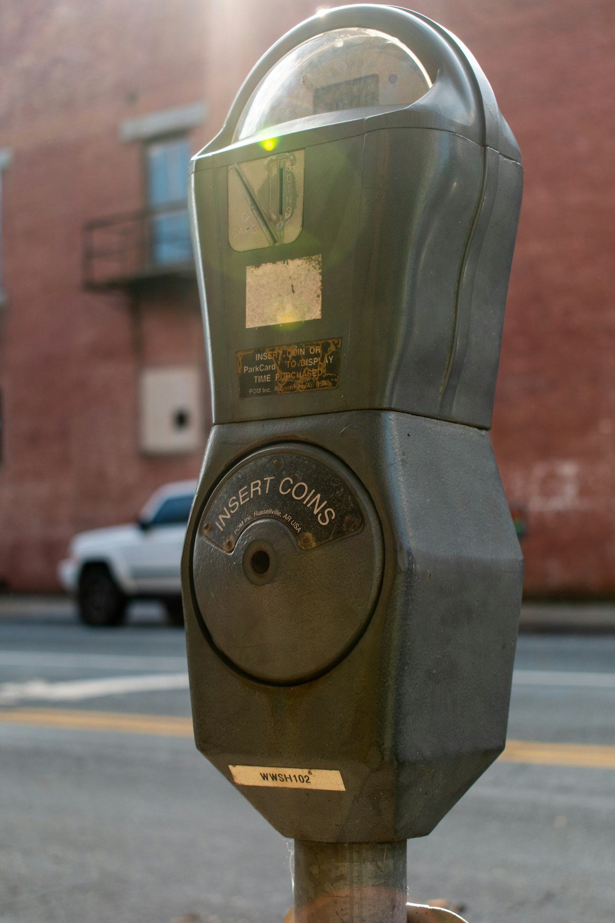 A parking meter with INSERT COINS label — representing GitHub Copilot's shift to usage-based billing where every token now has a price