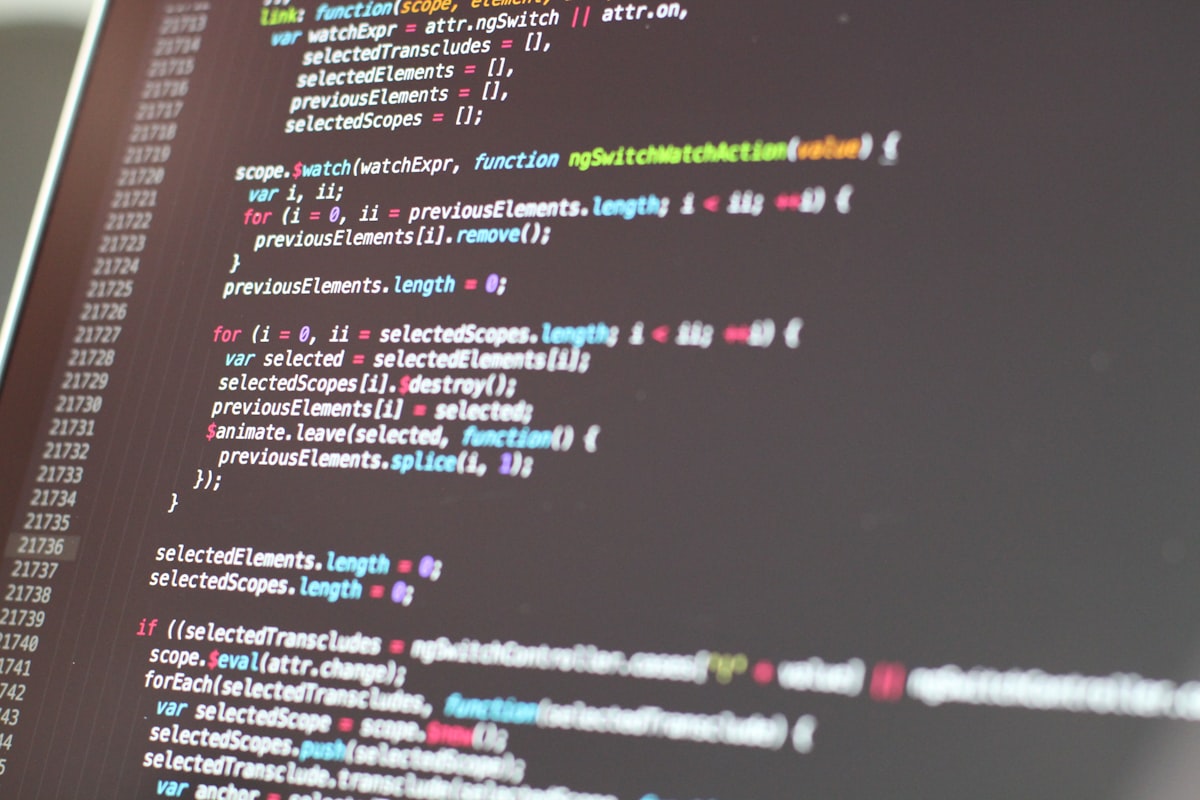 Monitor displaying code in a dark development environment — representing the late-night Xcode 26 migration sessions developers are pulling before Apple's SDK deadline