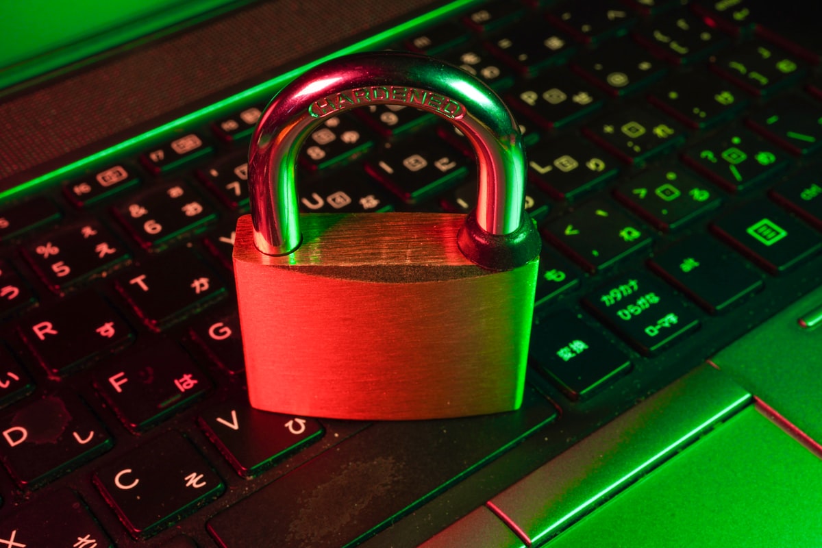 A red padlock resting on a black computer keyboard, symbolizing broken digital security