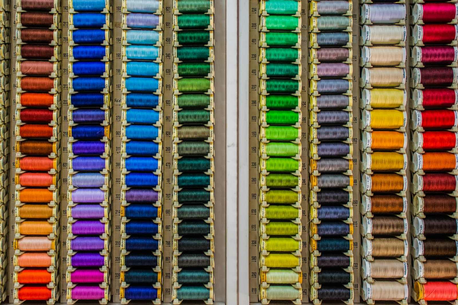 Colorful thread spools organized neatly on shelves — a visual metaphor for Swift's newly organized approach to concurrency