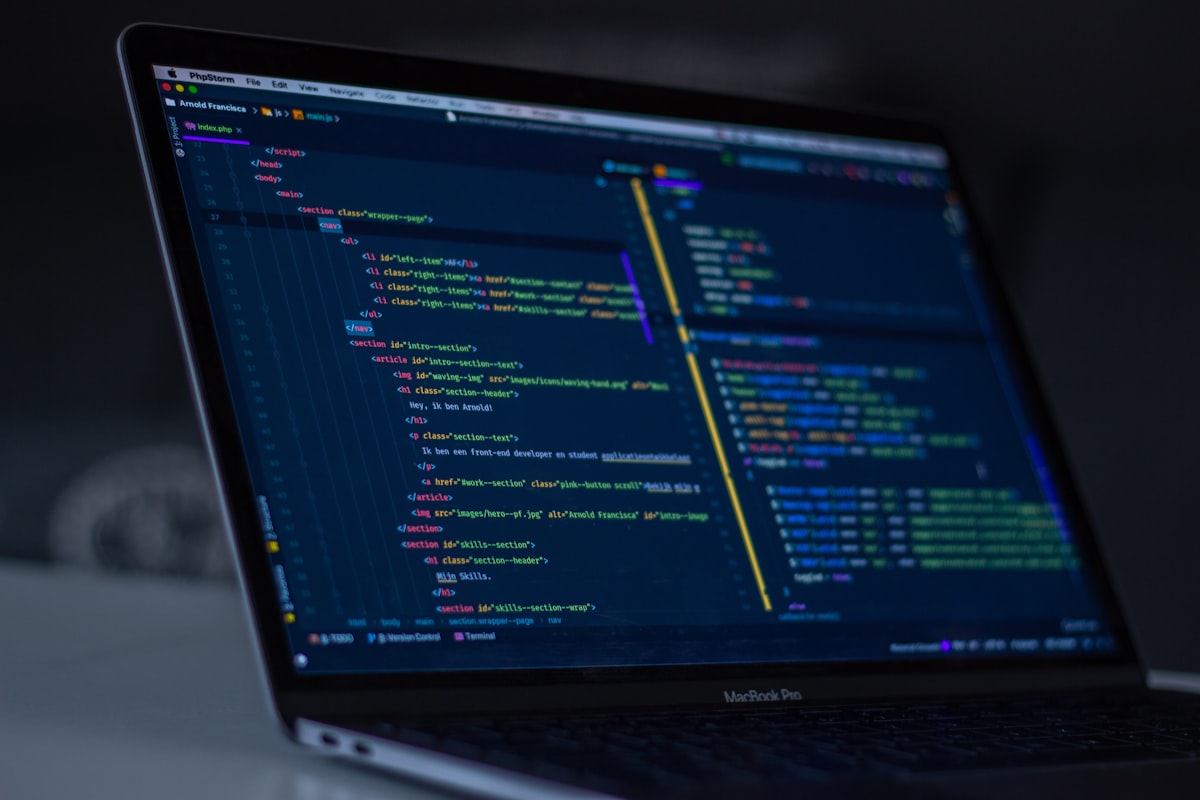 Lines of code on a dark monitor screen — representing the open source code that powers modern apps but receives less community support in the vibe coding era