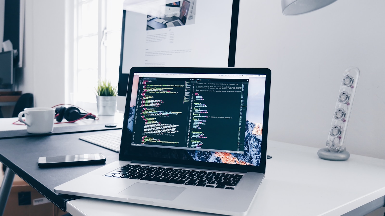 A developer workspace with a MacBook showing code on screen — representing the daily reality of working with AI coding agents in Xcode